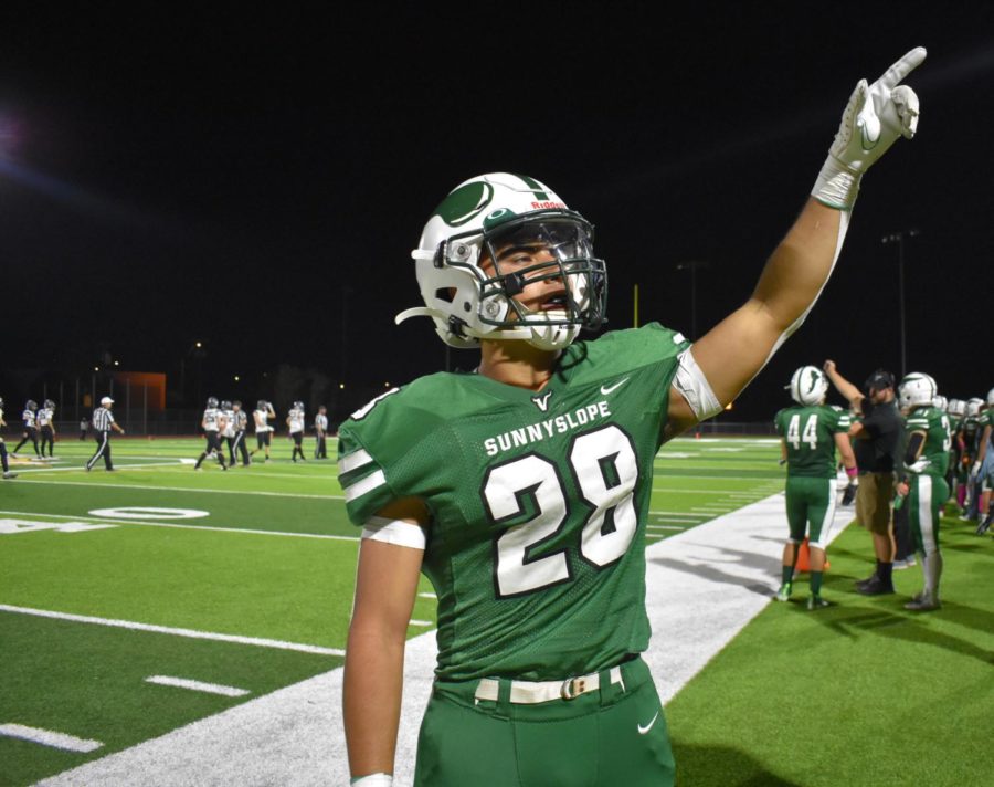 Senior Teague Perez points to the Green Team during the Homecoming Game.