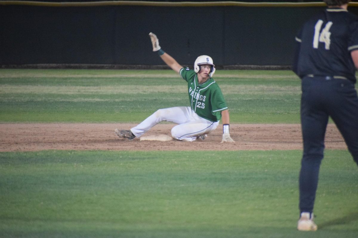 Senior Jackson Fredenberg calls for a timeout after successfully sliding into second base on his double.
