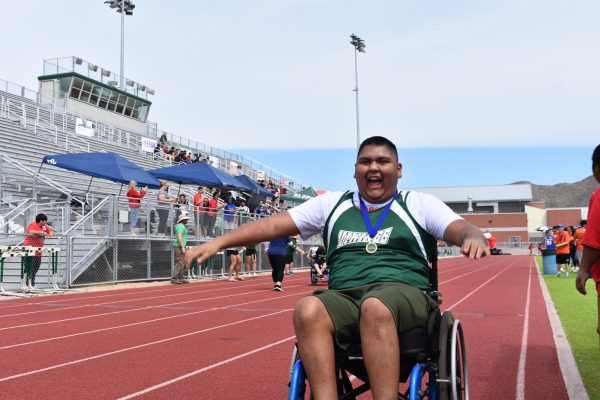 Junior Roberto Garcia rolls across the finish line at the District Unified Track Meet.